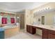 The bathroom features a soaking tub, separate shower, and dual sink vanity for convenience at 6156 41St E St, Bradenton, FL 34203