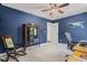 Study room with blue walls, a wooden cabinet and a rocking chair near windows at 6156 41St E St, Bradenton, FL 34203