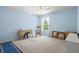 Bedroom with light blue walls, a rocking chair, and natural light from the window at 6156 41St E St, Bradenton, FL 34203