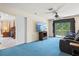 Spacious bonus room featuring comfortable seating, TV, balcony offering great views of the surrounding area at 6156 41St E St, Bradenton, FL 34203