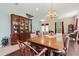Elegant dining room showcasing a chandelier, hardwood floors, and a large wooden table for entertaining at 6156 41St E St, Bradenton, FL 34203