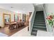 Elegant dining area with a large wooden table, chandelier, and staircase at 6156 41St E St, Bradenton, FL 34203