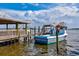 Dock featuring a waterfront boat rental with a weathered dock and peaceful coastal view on a beautiful sunny day with clouds at 6156 41St E St, Bradenton, FL 34203