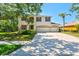 Attractive two-story home with a three-car garage, manicured lawn, and mature trees at 6156 41St E St, Bradenton, FL 34203