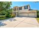 Beautiful two-story home boasts a three-car garage and manicured landscaping at 6156 41St E St, Bradenton, FL 34203