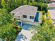 Aerial view of a two-story home with a well-manicured lawn, mature trees, and a three-car garage at 6156 41St E St, Bradenton, FL 34203