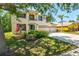 Charming two-story home with a three-car garage, manicured lawn, and mature trees at 6156 41St E St, Bradenton, FL 34203