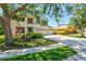Charming two-story home with a three-car garage, manicured lawn, and mature trees at 6156 41St E St, Bradenton, FL 34203