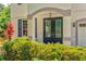 Charming front entrance with a decorative door, manicured landscaping, and inviting curb appeal at 6156 41St E St, Bradenton, FL 34203