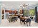 Open kitchen with stainless appliances, island seating, adjacent to a dining area and outdoor patio at 6156 41St E St, Bradenton, FL 34203