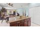 Open concept kitchen island with granite countertop and seating area, flowing into dining and entertainment space at 6156 41St E St, Bradenton, FL 34203