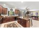 Open concept kitchen with center island, stainless steel appliances, and view of entertainment area at 6156 41St E St, Bradenton, FL 34203