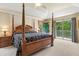 The main bedroom has a four-poster bed and access to a private balcony with scenic views at 6156 41St E St, Bradenton, FL 34203