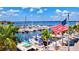A beautiful view of a marina filled with boats, clear blue water, palm trees, and an American flag waving in the breeze at 6156 41St E St, Bradenton, FL 34203