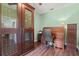 Inviting home office features a wine cabinet, rolltop desk and bright natural light creating a productive workspace at 6156 41St E St, Bradenton, FL 34203