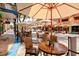 Charming sidewalk cafe with tables and chairs under umbrellas, offering a relaxed and inviting dining experience at 6156 41St E St, Bradenton, FL 34203