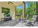 Outdoor screened patio with barbecue grill and seating area, great for entertaining at 6156 41St E St, Bradenton, FL 34203