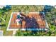 An aerial view of the community playground with swings and slides, surrounded by lush greenery and mature trees at 6156 41St E St, Bradenton, FL 34203