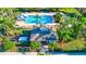 An aerial view highlighting a community pool with inviting lounge chairs surrounded by lush landscaping and palm trees at 6156 41St E St, Bradenton, FL 34203