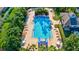An aerial view showcasing the sparkling community pool with lounge chairs, lush landscaping, and a waterslide at 6156 41St E St, Bradenton, FL 34203