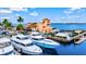 Waterfront views highlight this boat dock and restaurant with parking, palms and blue skies above yachts and the pier at 6156 41St E St, Bradenton, FL 34203