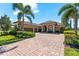Beautiful home with a red tile roof, a three-car garage, and a brick driveway at 629 River Enclave Ct, Bradenton, FL 34212