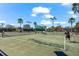 A view of a tennis court during a match with people playing at 629 River Enclave Ct, Bradenton, FL 34212