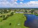 Golf course aerial view with scenic views of golf course, lakes and community buildings at 6511 Turners Gap Rd, Bradenton, FL 34203