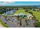 Tara Golf and Country Club's golf course, lake, clubhouse, tennis court, and parking lot in aerial view at 6511 Turners Gap Rd, Bradenton, FL 34203