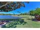 Picturesque backyard featuring a tranquil lake view and manicured landscaping at 6511 Turners Gap Rd, Bradenton, FL 34203
