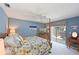 Bedroom with a four-poster bed, ceiling fan, and a view of the screened patio at 6511 Turners Gap Rd, Bradenton, FL 34203