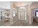 Elegant entryway with decorative molding, chandelier, and view into the living spaces at 6511 Turners Gap Rd, Bradenton, FL 34203