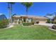 Beautiful exterior of a single-story home with lush landscaping and a well-maintained lawn at 6511 Turners Gap Rd, Bradenton, FL 34203