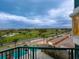 Scenic balcony view of lush golf course and distant cityscape under cloudy sky at 655 Longboat Club Rd # 16B, Longboat Key, FL 34228