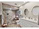 Updated bathroom features a double vanity, modern fixtures, and a spacious walk-in shower at 7223 Wood Creek Dr # 22, Sarasota, FL 34231