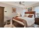 Bedroom with a ceiling fan, two windows, and decorations on the walls at 7223 Wood Creek Dr # 22, Sarasota, FL 34231