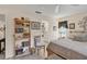 Bedroom with a bookshelf, and a peek into a charming bathroom with a chair in the entry at 7223 Wood Creek Dr # 22, Sarasota, FL 34231