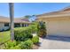Well-maintained home exterior with a lush, green landscaped yard and charming plants at 7223 Wood Creek Dr # 22, Sarasota, FL 34231
