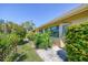 Home exterior with a lawn and walkway to the back door at 7223 Wood Creek Dr # 22, Sarasota, FL 34231