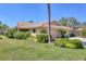 Exterior of a home with a green lawn and a driveway leading up to the garage at 7223 Wood Creek Dr # 22, Sarasota, FL 34231
