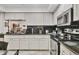 Modern kitchen boasts granite countertops, black backsplash, and stainless steel appliances for easy cooking at 7223 Wood Creek Dr # 22, Sarasota, FL 34231