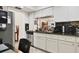 Bright kitchen featuring white cabinets, granite counters, and stainless steel appliances for efficient meal prep at 7223 Wood Creek Dr # 22, Sarasota, FL 34231