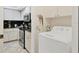 Laundry room with a full sized washer with a kitchen visible in the background at 7223 Wood Creek Dr # 22, Sarasota, FL 34231