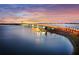 Beautiful aerial view of a bridge and ocean at dusk; picturesque scenery with palm trees and city skyline in the background at 750 N Tamiami Trl # 604, Sarasota, FL 34236