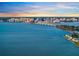 Aerial view of a bridge over a large body of water with a city skyline in the background at 750 N Tamiami Trl # 604, Sarasota, FL 34236