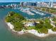 An aerial view of a recreational area, a marina, and beautiful blue water surrounding the island at 750 N Tamiami Trl # 604, Sarasota, FL 34236