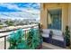 Charming balcony featuring stylish outdoor seating, verdant plants, and captivating urban views, providing a perfect retreat at 750 N Tamiami Trl # 604, Sarasota, FL 34236