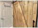 Rustic barn door next to white door, adding character and charm to the space at 750 N Tamiami Trl # 604, Sarasota, FL 34236