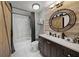 Bathroom featuring marble tile, a dark wood vanity, and a sliding barn door accent at 750 N Tamiami Trl # 604, Sarasota, FL 34236