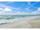Calm beach view with gentle waves rolling onto the sand on a sunny day at 750 N Tamiami Trl # 604, Sarasota, FL 34236